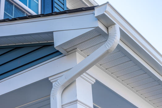 Detailed white soffit, fascia, and gutter corner install on a Palm Coast home