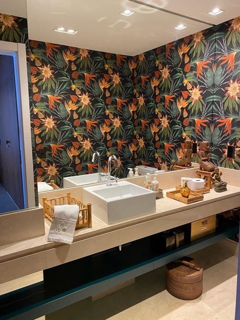 Powder bathroom with bold bird of paradise tropical wallpaper, stone vessel sink, and floating vanity by Jeff Handyman